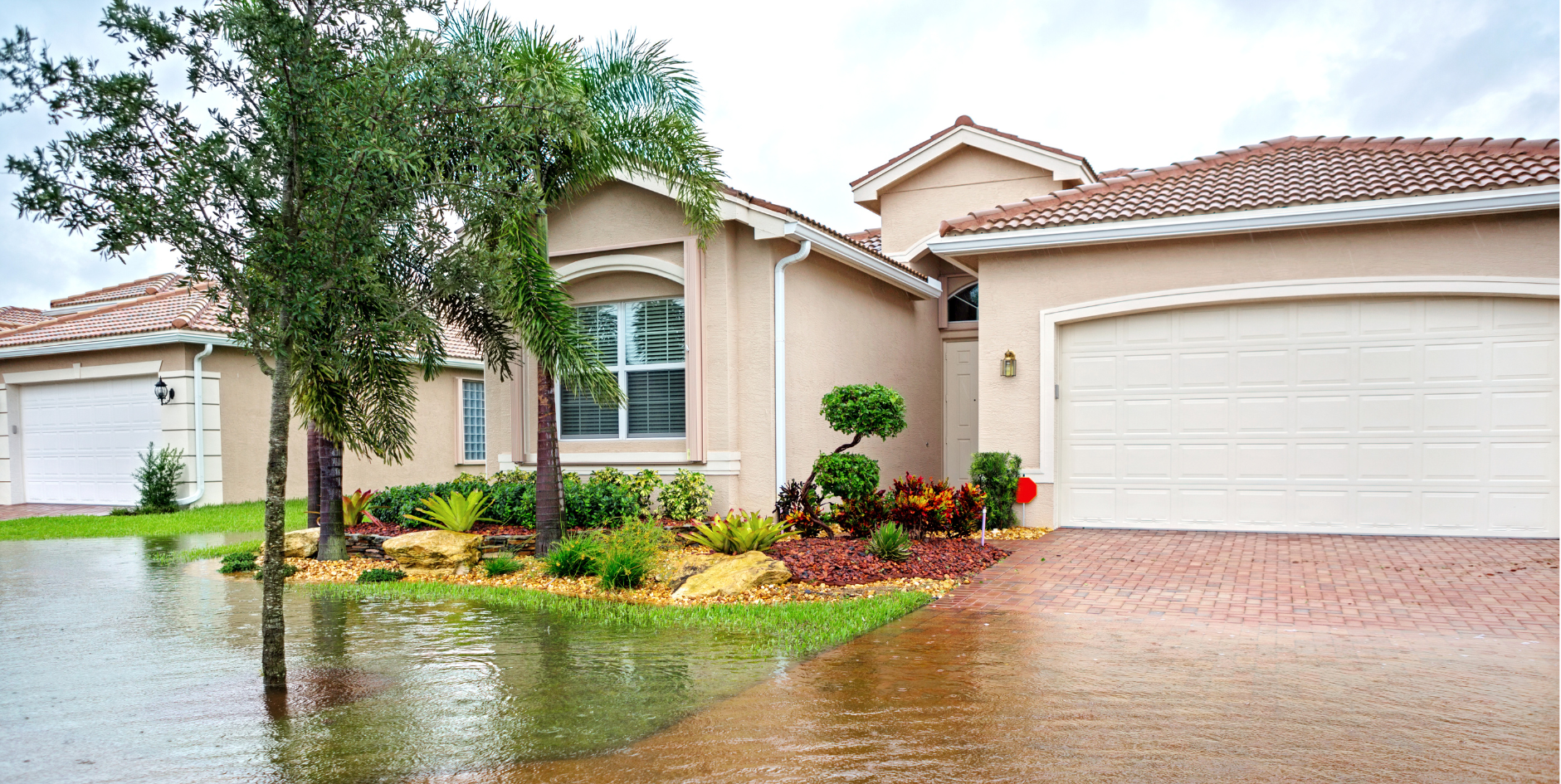 House with flooded garden out the front.